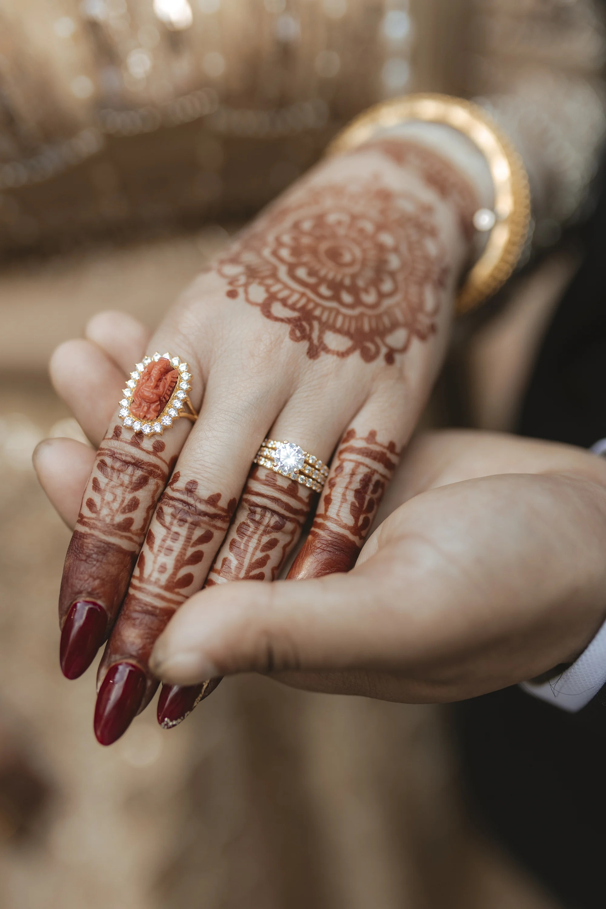 Wedding rings and intricate mehndi details