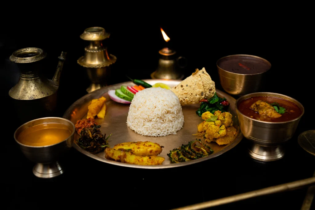 Nepali dining spread photographed by warm lamplight