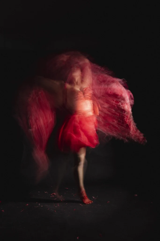 Layered movement study of a dancer in red